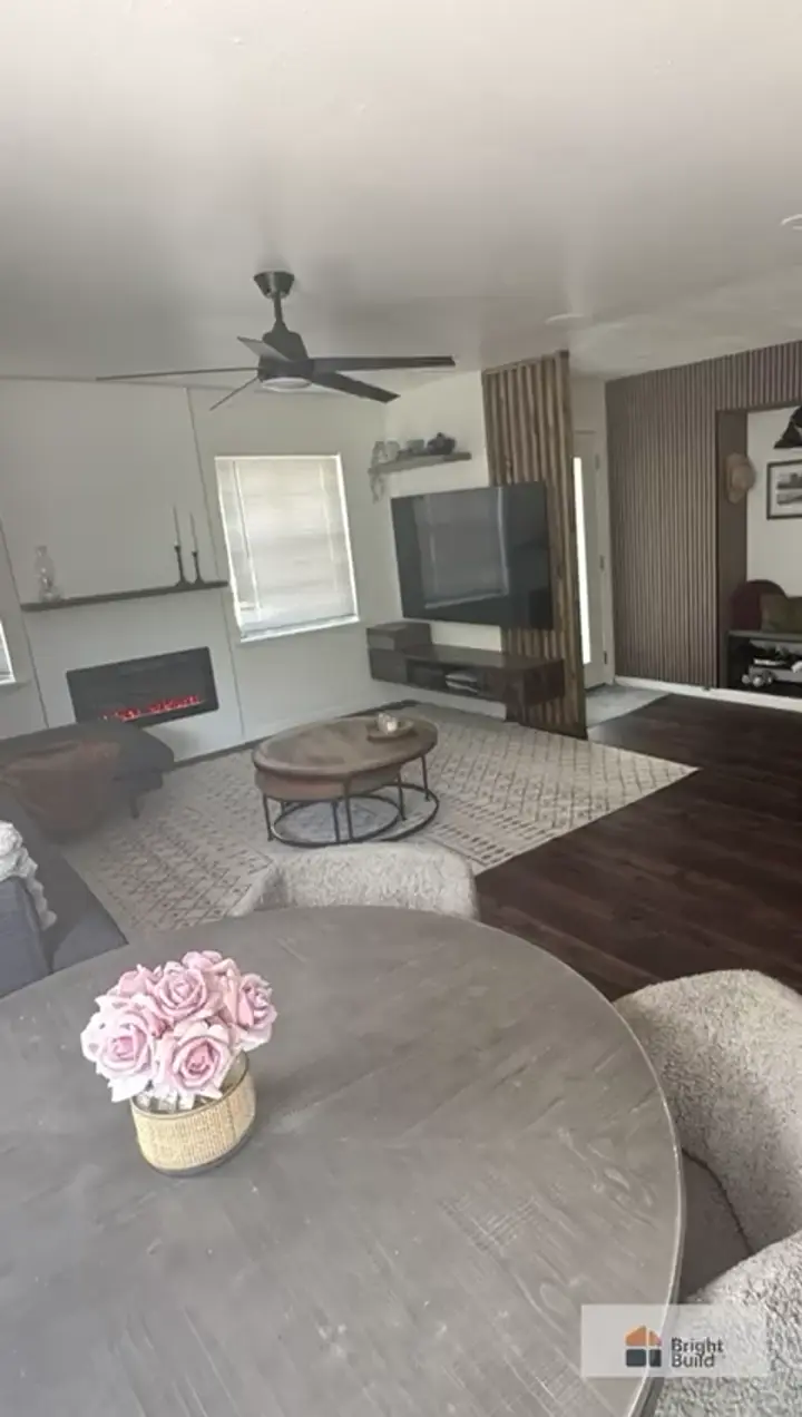 Completed Bright Build residential improvement with a modern fireplace and coordinated wood details.